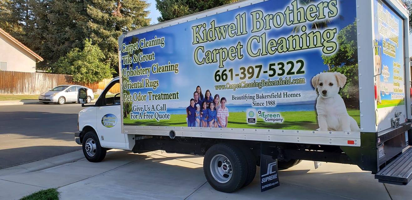 A moving truck parked on the side of the road